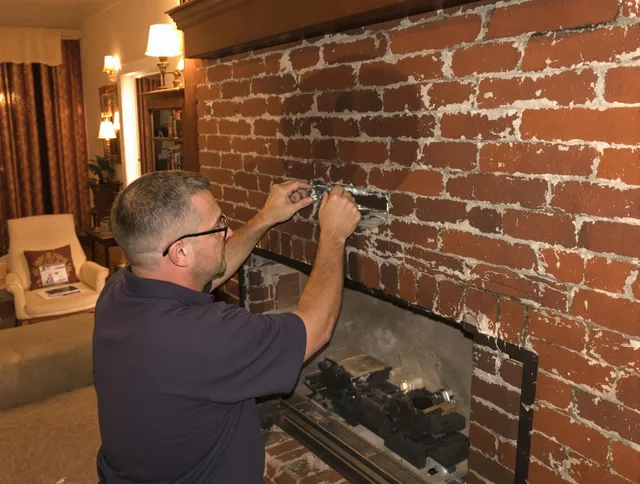 Meriden Chimney Sweep expert fixing a fireplace in Meriden, CT